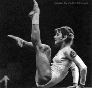 photo of gymnast Olga Korbut in a pose on balance beam